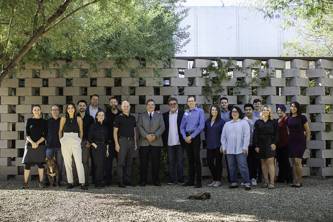 AIA Arizona members smile in front of geometric wall